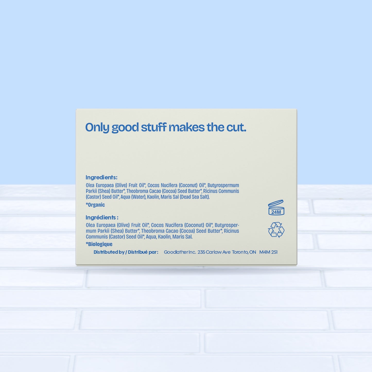 A Goodlather Unscented Soap Bar package with “Only good stuff makes the cut.” and a list of natural ingredients is displayed on a light blue and beige background, atop a white tile surface. The packaging highlights its natural ingredients.