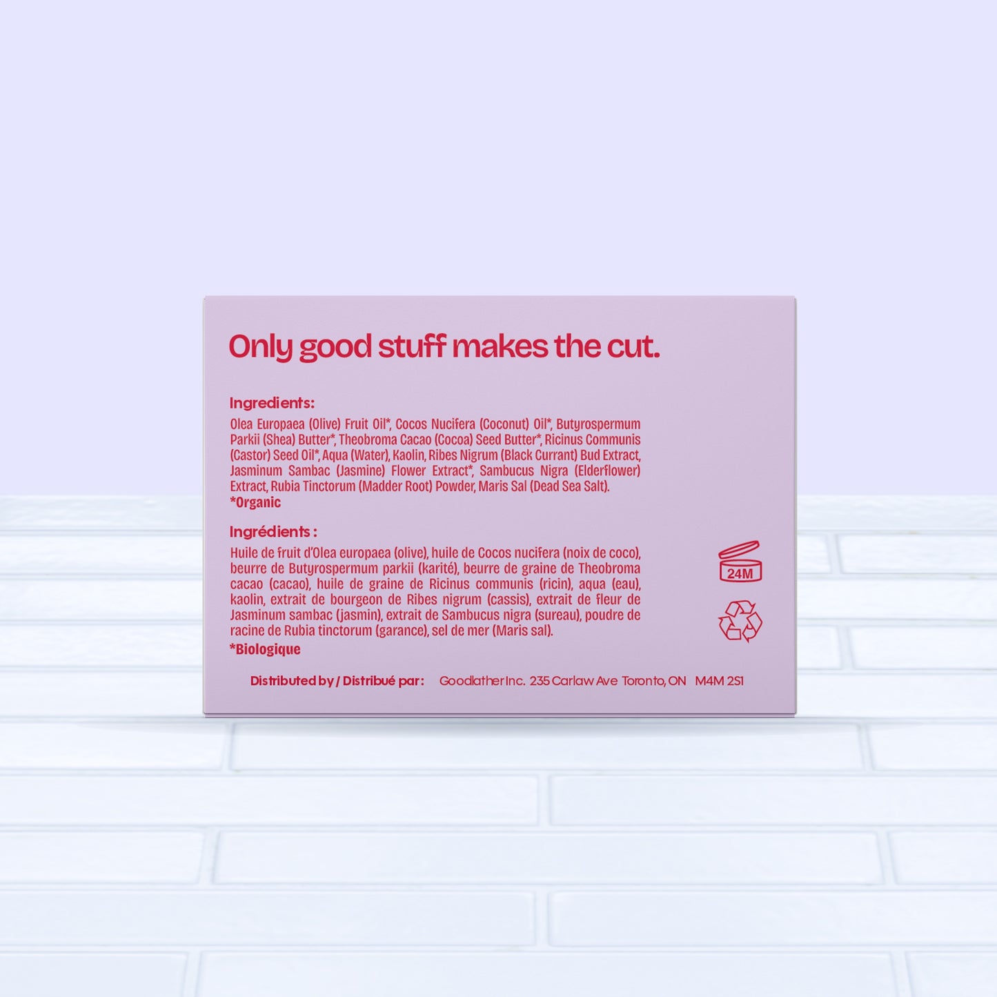 A bold red &amp; pink Goodlather Black Currant and Jasmine Bar Soap box displays ingredients in English and French, with Only good stuff makes the cut. in bold red at the top. The sustainable, all-natural bar sits on light tile with a pale blue background.